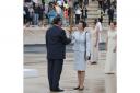 The Princess Royal is handed the torch during the official handover ceremony of the Olympic Flame at the Panathenaic Stadium