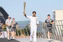 HONOUR: Richard Parks carries the Olympic Torch in Swansea on Saturday