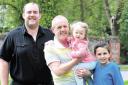 PROUD: Kelvin Perrett, 65, from Cwmbran will carry the Olympic torch. He is pictured with stepson Rhodri Thomas and grandchildren Stuart Waldron and Grace Thomas