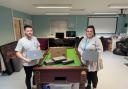 Convey Law conveyancer Alex Harris donating the laptops to Katie Jones from Monlife Youth Service