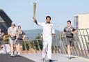 HONOUR: Richard Parks carries the Olympic Torch in Swansea on Saturday