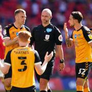CONTROVERSIAL: Bobby Madley is surrounded by County after giving a penalty