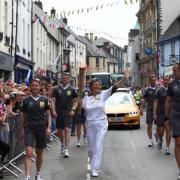 Lyn Hull carries the torch through Abergavenny town centre