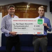 AWARD: Monmouth RFC club secretary Byron Hapgood, left, receives his prize from Peter Townsend of Peter's