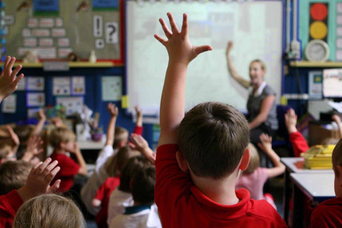 File photo dated 06/07/11 of children at school raising their hands to answer a question as a third of parents think school trips are unaffordable, while many others think the costs of uniforms and equipment are too high, a poll suggests. PRESS ASSOCIATIO