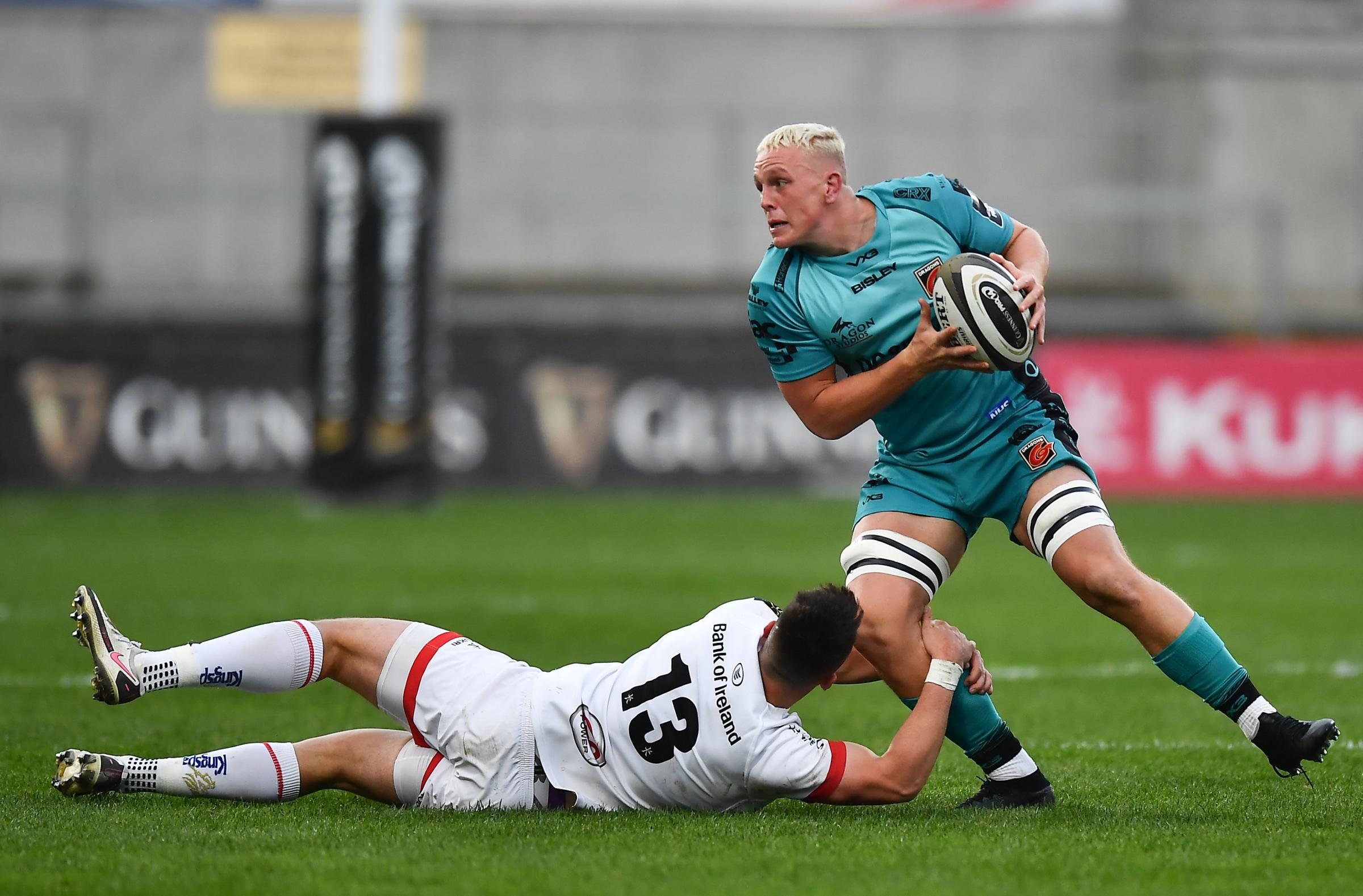 Ben Fry of Dragons is tackled by James Hume of Ulster