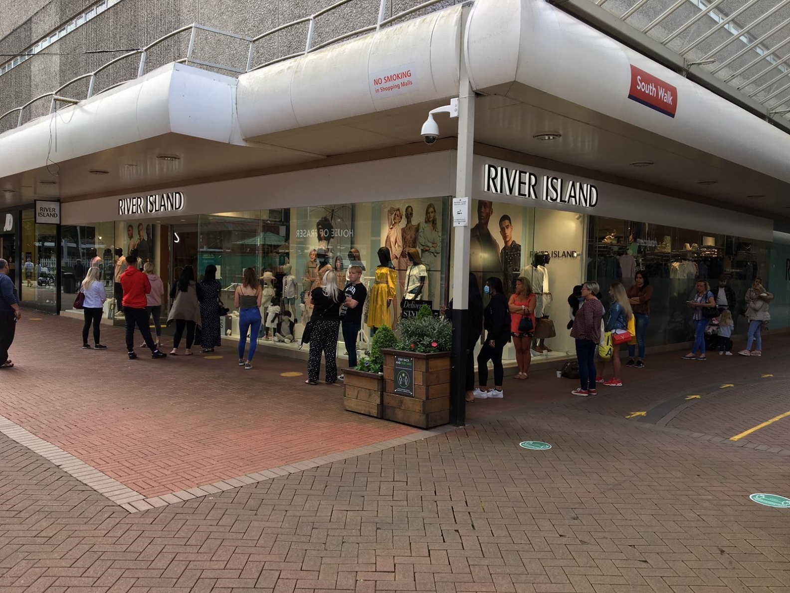 Shoppers queuing outside River Island in Cwmbran when it reopened after the first lockdown last June