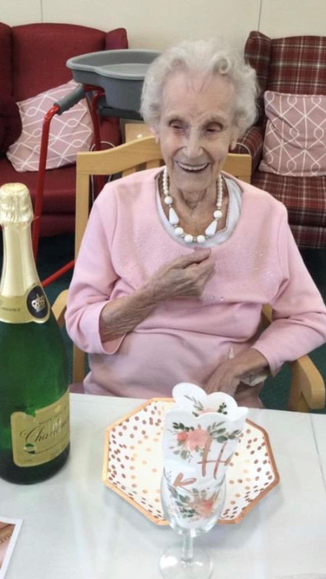 Winifred Williams celebrates her 103rd birthday with a glass of bubbly. Picture: Arthur Jenkins Care Home