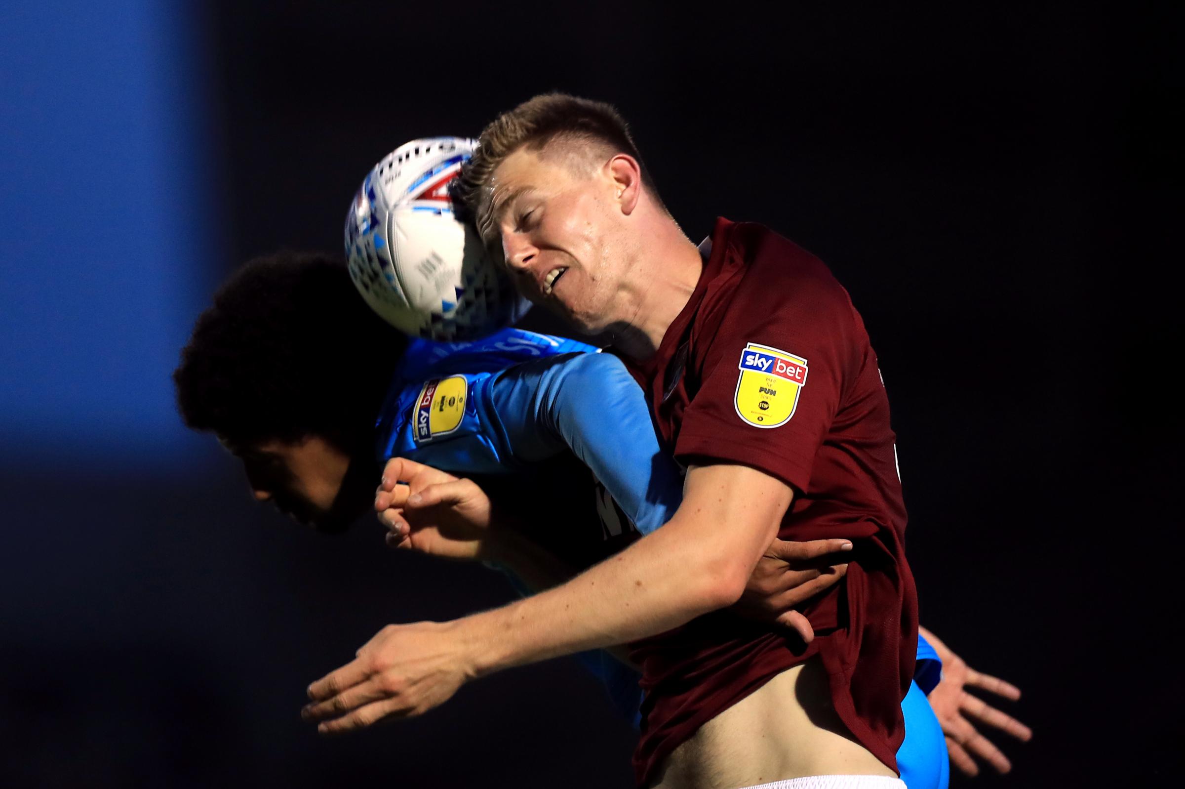 Northampton Towns Scott Wharton and Cheltenham Towns Jonte Smith (left) battle for the ball during the Sky Bet League Two play-off semi final first leg match at the PTS Academy Stadium, Northampton..