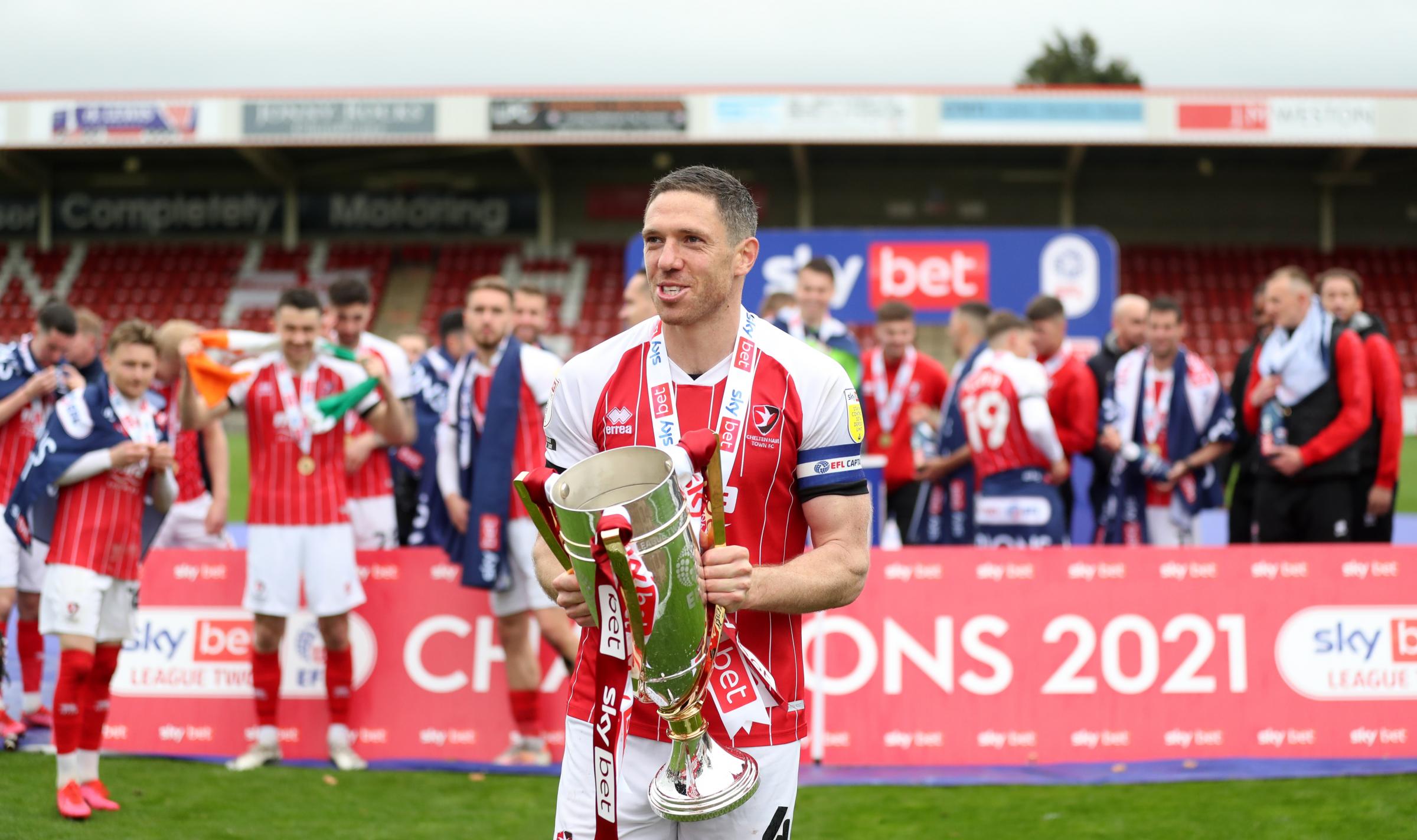 Cheltenham Towns Ben Tozer celebrates with the League Two trophy