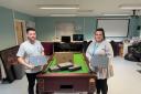 Convey Law conveyancer Alex Harris donating the laptops to Katie Jones from Monlife Youth Service