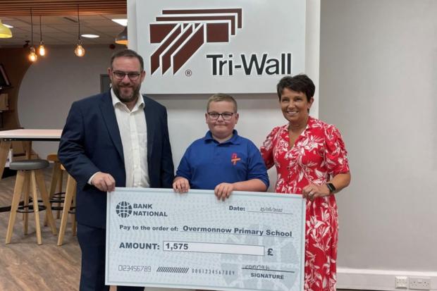 Effort: Connah Jones, 11, centre, who has raised almost £2,000, including a £250 donation from Monmouth firm Tri-Wall