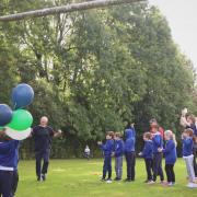 Headteacher Roger Guy cheered on by pupils