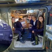 Children at Usk Church in Wales Primary inside the tank and (inset) Alastair Scott of Tank School