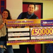 Helen Douglas receiving her winnings from Club 3000 Cwmbran manager Paul Hughes. Picture: Club 3000 Bingo.