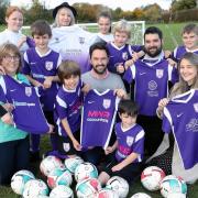 Helen Tilley of Monnow Eye Care, Sue Bayliss of Andrew Bayliss Hairdressers, Gareth Watkins of MWR accountants, Paul Watkins of Blackhouse Travel, and Amber Evans of Raglan Country Estates with Raglan junior players. Picture: Michael Hall Photography.