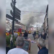 Photographs from the scene show a heavy emergency services presence in Monnow Street, with firefighters using an aerial ladder to tackle the flames.