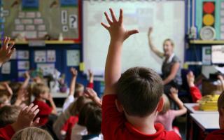 File photo dated 06/07/11 of children at school raising their hands to answer a question as a third of parents think school trips are unaffordable, while many others think the costs of uniforms and equipment are too high, a poll suggests. PRESS ASSOCIATIO