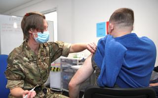 Pictured: Sgt Stus, CTC, Royal Marines, Lympstone, administering a COVID 19 booster jab to a member of the public