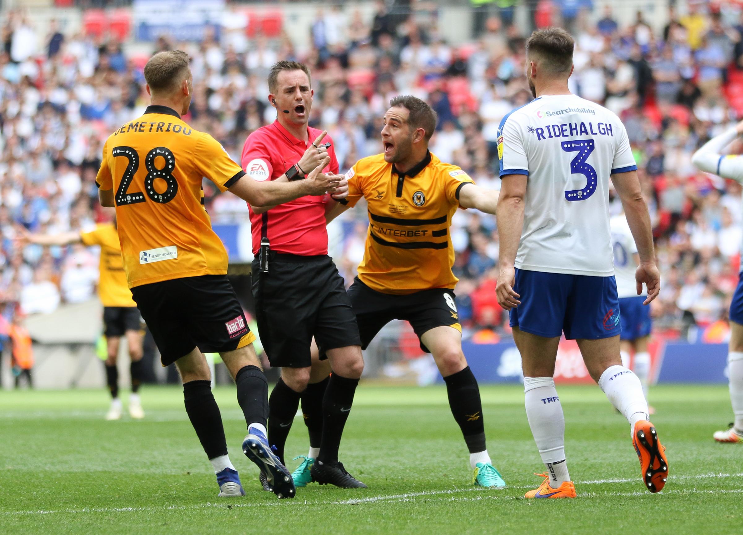 25.05.19 - Newport County v Tranmere Rovers, Sky Bet League 2 Play-Off Final - Mickey Demetriou of Newport County and Matty Dolan of Newport County appeal to referee Ross Joyce after Jamille Matt of Newport County is brought down by Emmanuel Monthe of